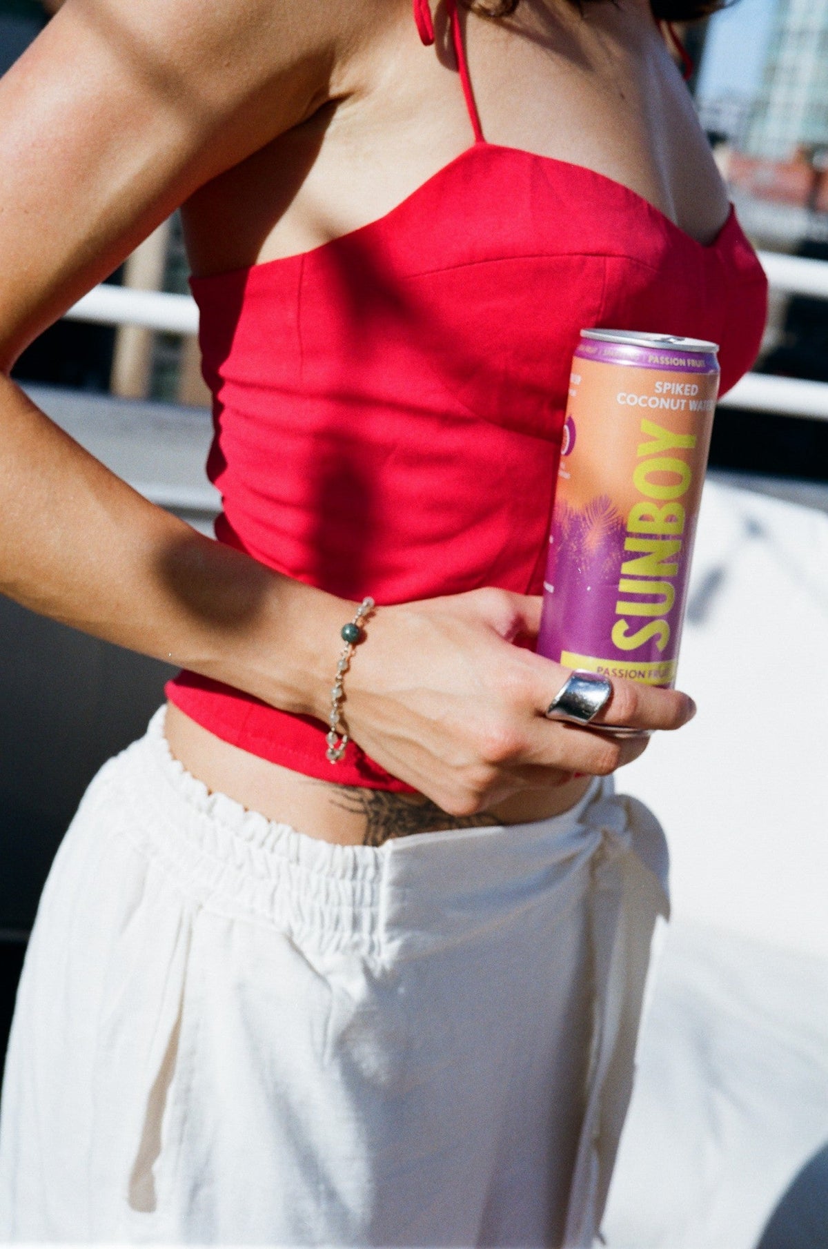 Friend in a red top holding a can of SUNBOY